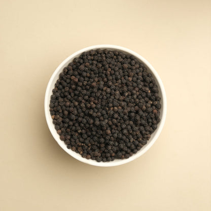 Close-up of whole black peppercorns showing quality and freshness, perfect for grinding