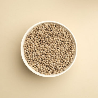 Whole white peppercorns showing premium quality, perfect for cream sauces and refined cooking