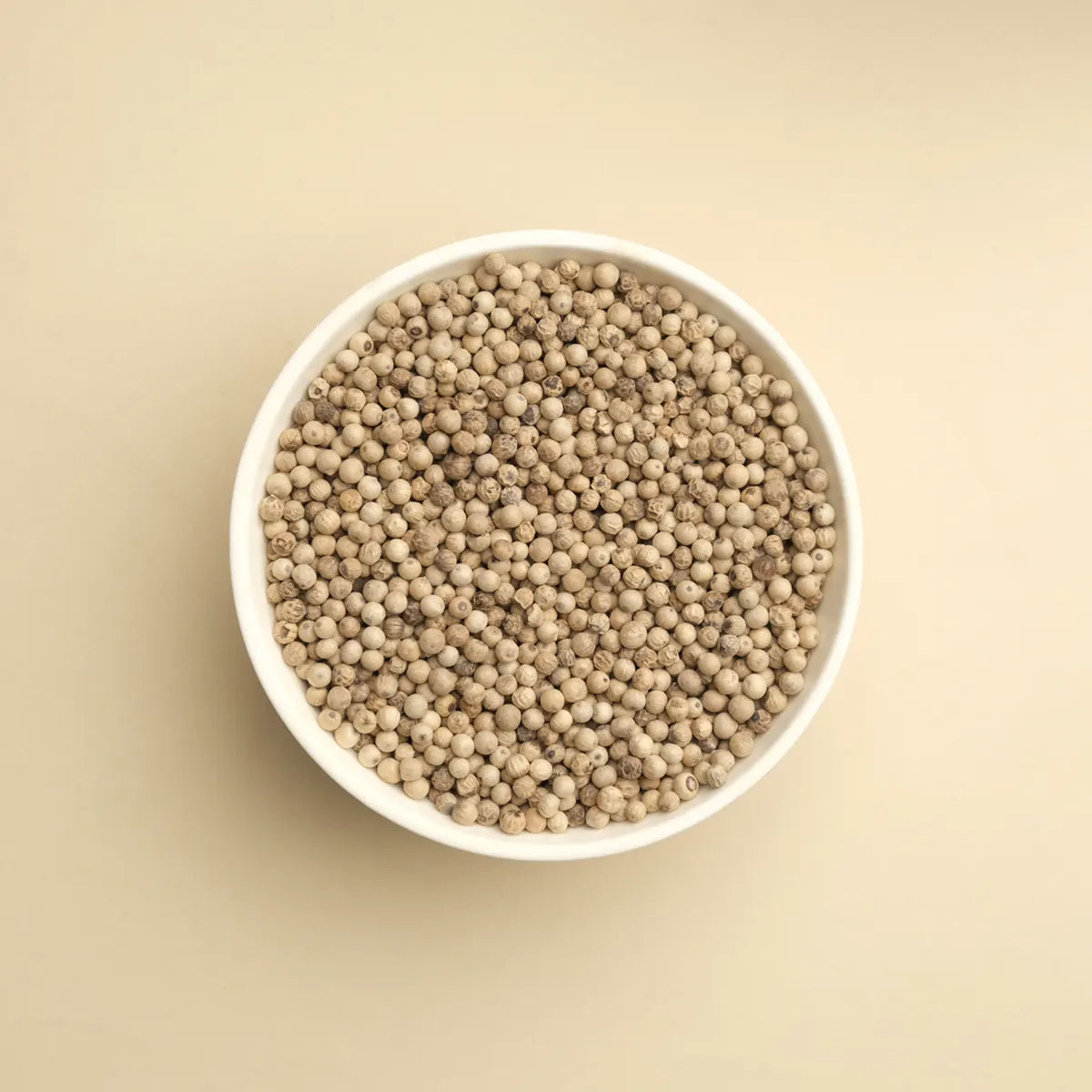 White pepper whole peppercorns in a bowl