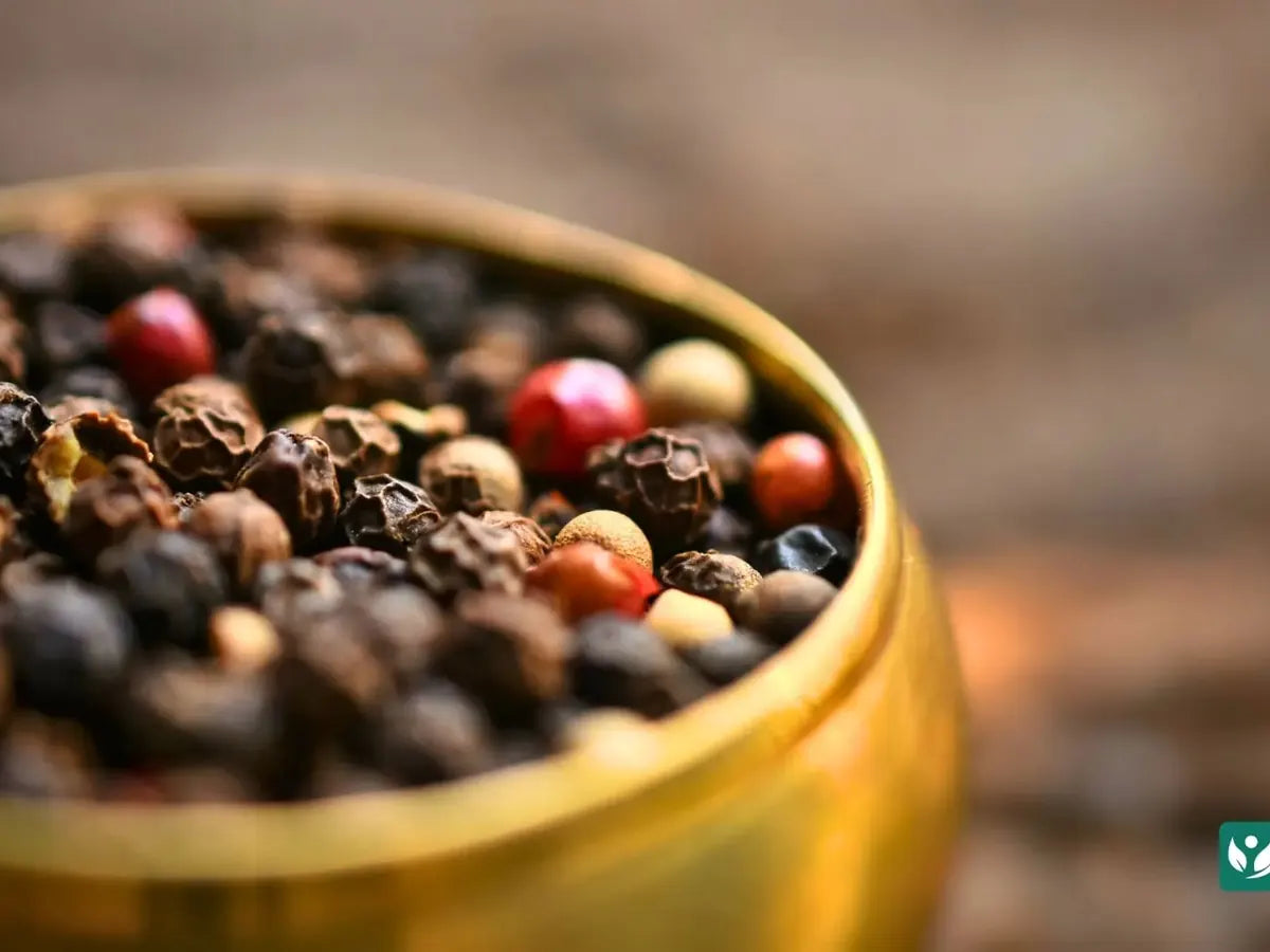 Close view of whole black peppercorns